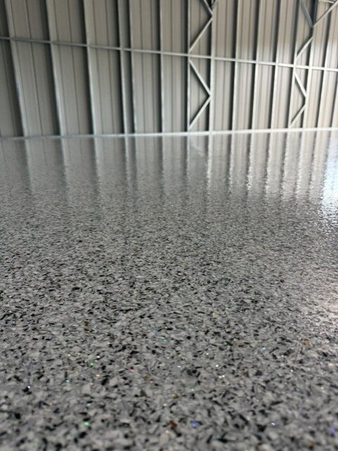 Close up of grey flake epoxy coating with sparkle finish