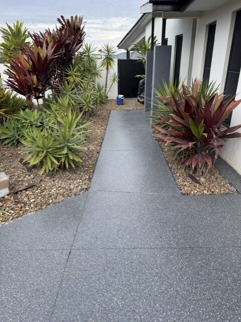Garden path grey flake epoxy coating through landscaped beds by Premium Epoxy Flooring