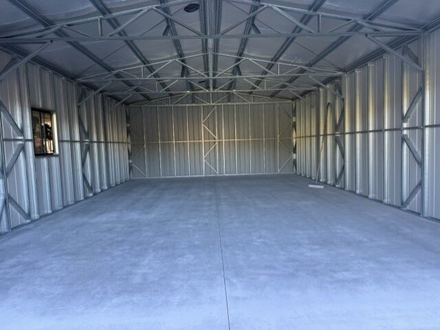 Steel shed interior bare concrete floor before epoxy coating