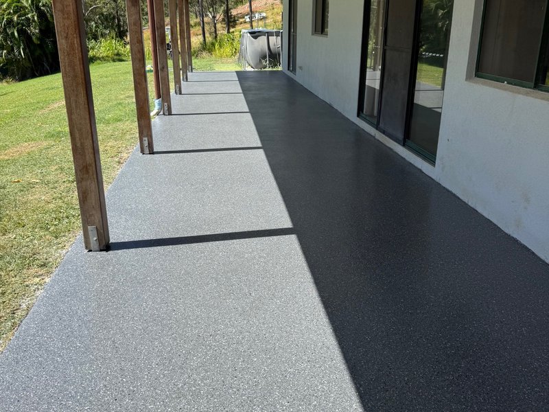 Verandah epoxy flooring completed — grey flake coating on covered patio by Premium Epoxy Flooring